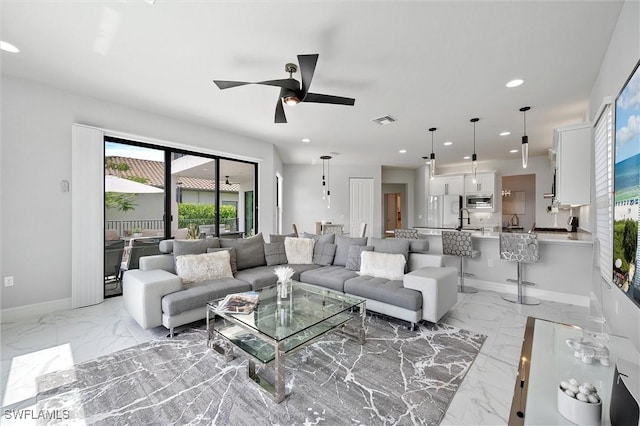 4692 Kensington Cir, Naples, FL 34119 - living room featuring light marble finish floors, a ceiling fan, and recessed lighting