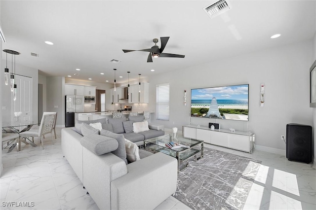 4692 Kensington Cir, Naples, FL 34119 - living room featuring light marble finish flooring, recessed lighting, and ceiling fan