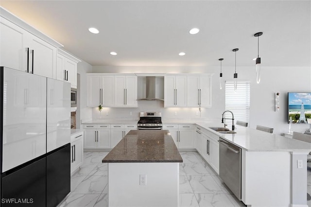 4692 Kensington Cir, Naples, FL 34119 - kitchen with wall chimney range hood, stainless steel appliances, a peninsula, light marble finish flooring, and recessed lighting