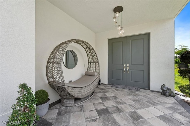 4692 Kensington Cir, Naples, FL 34119 - property entrance with stucco siding and french doors