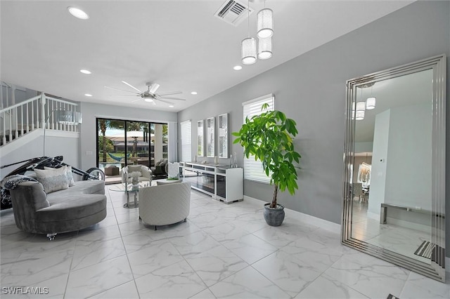 4692 Kensington Cir, Naples, FL 34119 - living area featuring recessed lighting, ceiling fan, light marble finish floors, and stairs
