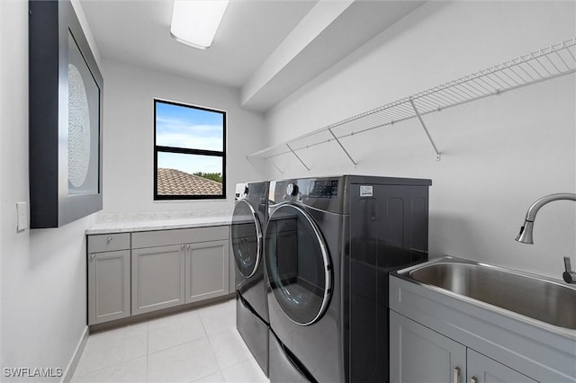 4692 Kensington Cir, Naples, FL 34119 - washroom featuring washing machine and dryer, cabinet space, and light tile patterned floors