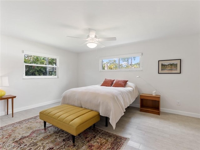 3704 Blue Heron Dr, Fort Myers, FL 33908 - bedroom featuring multiple windows, light wood-style flooring, and a ceiling fan