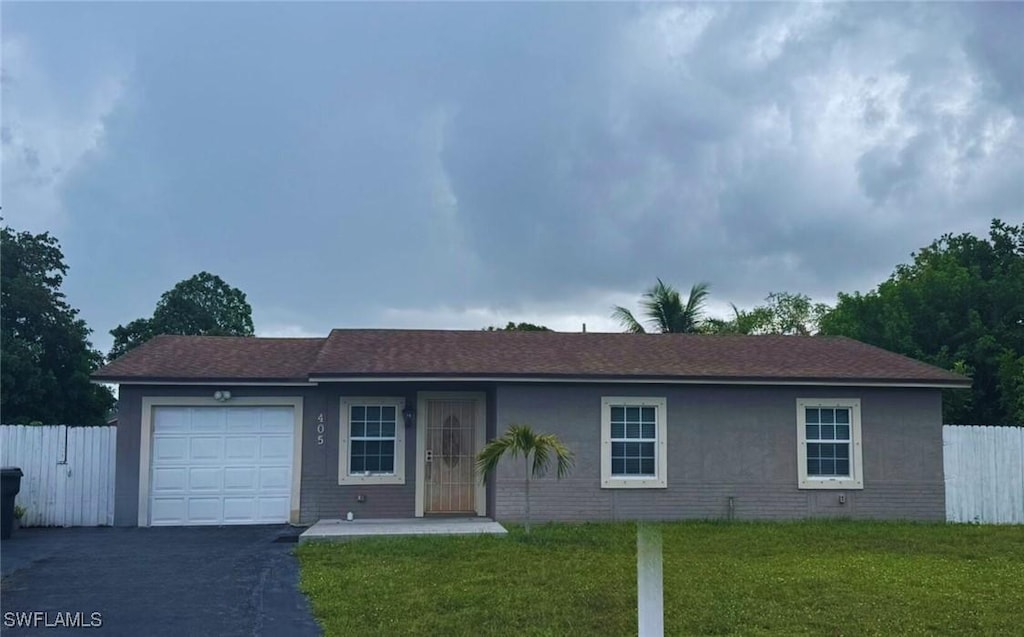 405 SW 79th Ter, North Lauderdale, FL 33068 - ranch-style home featuring an attached garage, asphalt driveway, and stucco siding