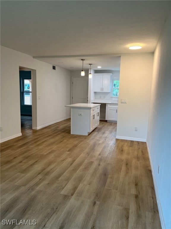 16881 Davis Rd Unit 713, Fort Myers, FL 33908 - unfurnished living room with wood finished floors and healthy amount of natural light