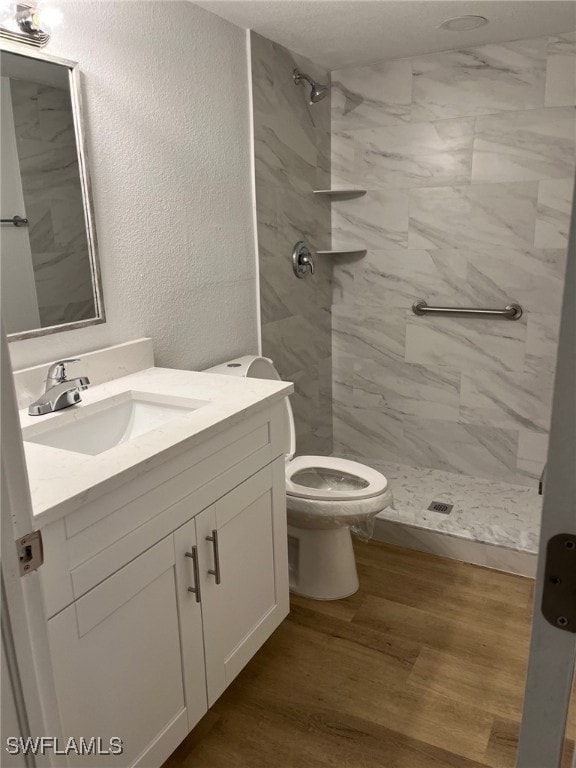 16881 Davis Rd Unit 713, Fort Myers, FL 33908 - full bath with vanity, a marble finish shower, wood finished floors, and a textured wall