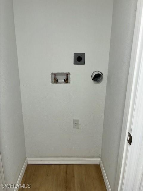 16881 Davis Rd Unit 713, Fort Myers, FL 33908 - washroom featuring hookup for an electric dryer, hookup for a washing machine, and wood finished floors