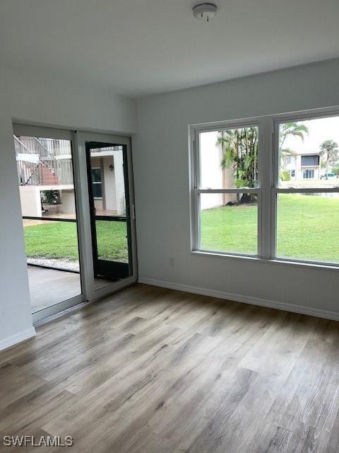 16881 Davis Rd Unit 713, Fort Myers, FL 33908 - unfurnished room with plenty of natural light and wood finished floors