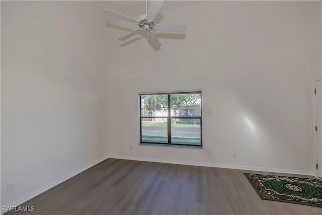 8441 N Haven Ln Unit B, Fort Myers, FL 33919 - unfurnished room featuring dark wood-style flooring, a ceiling fan, and a towering ceiling