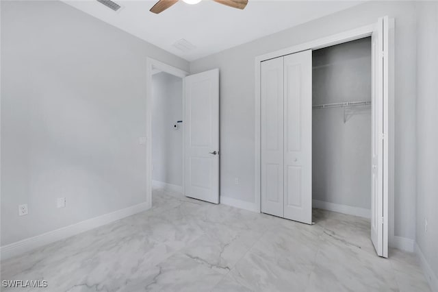 4447 26th Ave SE, Naples, FL 34117 - unfurnished bedroom featuring a closet, ceiling fan, and marble look tiles