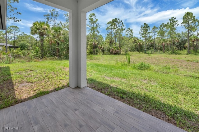 4447 26th Ave SE, Naples, FL 34117 - wooden deck featuring a yard