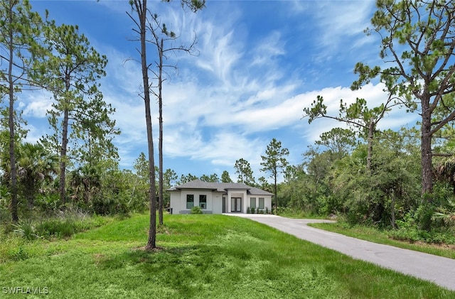 4447 26th Ave SE, Naples, FL 34117 - view of front facade with a front lawn and stucco siding
