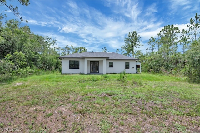 4447 26th Ave SE, Naples, FL 34117 - rear view of property with stucco siding and a lawn