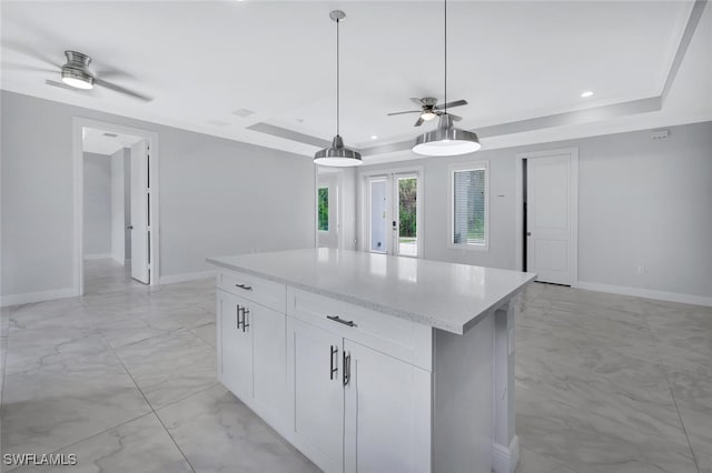 4447 26th Ave SE, Naples, FL 34117 - kitchen featuring ceiling fan, a raised ceiling, light marble finish floors, a center island, and recessed lighting