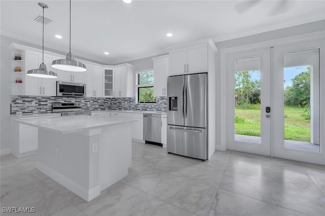 4447 26th Ave SE, Naples, FL 34117 - kitchen with appliances with stainless steel finishes, french doors, tasteful backsplash, open shelves, and a center island