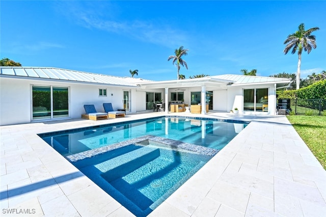 646 Park Shore Dr, Naples, FL 34103 - back of house featuring outdoor lounge area, a metal roof, a standing seam roof, a patio area, and stucco siding