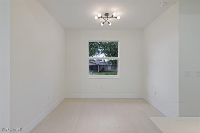 3801 14th St W, Lehigh Acres, FL 33971 - unfurnished room with a chandelier and a smoke detector