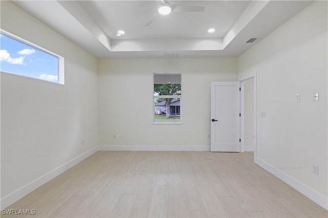 3801 14th St W, Lehigh Acres, FL 33971 - spare room with a raised ceiling, ceiling fan, light wood-style floors, and recessed lighting