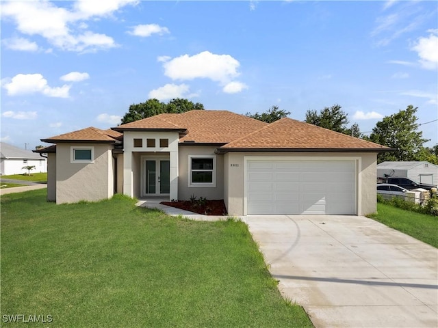 3801 14th St W, Lehigh Acres, FL 33971 - prairie-style home featuring stucco siding, french doors, a garage, and a front yard