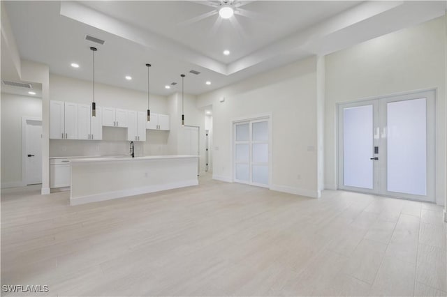3801 14th St W, Lehigh Acres, FL 33971 - unfurnished living room with a ceiling fan, recessed lighting, light wood-type flooring, french doors, and a towering ceiling