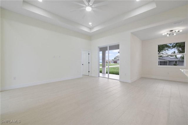 3801 14th St W, Lehigh Acres, FL 33971 - empty room featuring a tray ceiling, light wood finished floors, a ceiling fan, and recessed lighting