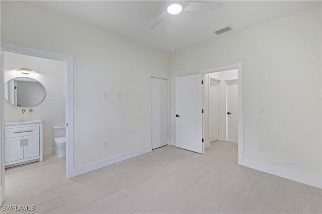 3801 14th St W, Lehigh Acres, FL 33971 - unfurnished bedroom featuring light wood finished floors, ensuite bath, a closet, and ceiling fan