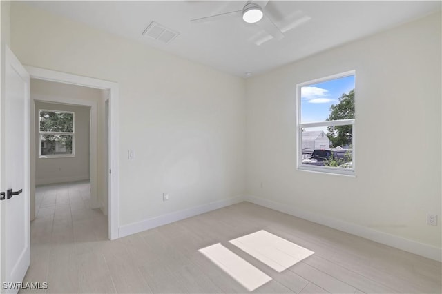 3801 14th St W, Lehigh Acres, FL 33971 - unfurnished room featuring plenty of natural light, light wood-style flooring, and ceiling fan
