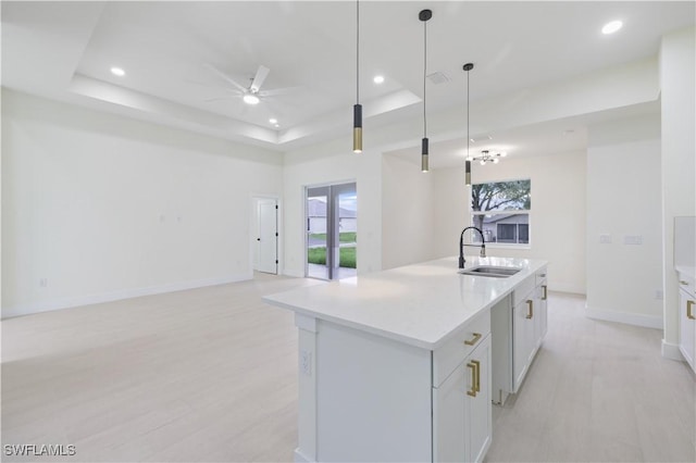 3801 14th St W, Lehigh Acres, FL 33971 - kitchen featuring a ceiling fan, a tray ceiling, open floor plan, a center island with sink, and recessed lighting