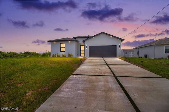 7071 Tide Cir, Labelle, FL 33935 - view of front of home featuring stucco siding, an attached garage, driveway, and a front lawn