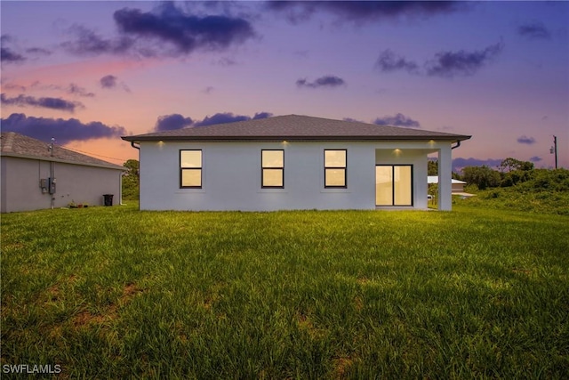 7071 Tide Cir, Labelle, FL 33935 - back of house with a lawn and stucco siding
