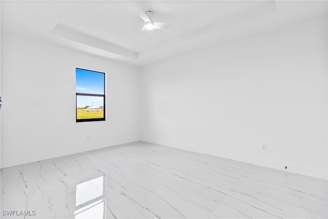 7071 Tide Cir, Labelle, FL 33935 - spare room featuring a raised ceiling, marble finish floors, and ceiling fan