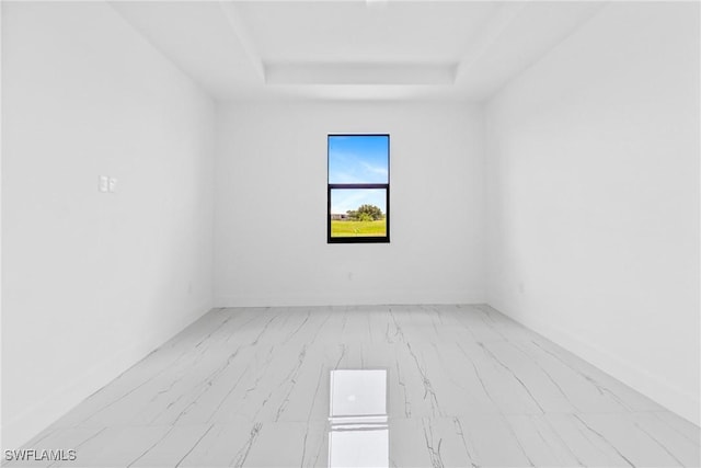 7071 Tide Cir, Labelle, FL 33935 - spare room featuring a raised ceiling and marble look tile flooring