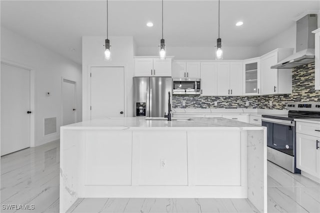 7071 Tide Cir, Labelle, FL 33935 - kitchen featuring stainless steel appliances, wall chimney range hood, decorative backsplash, a kitchen island with sink, and recessed lighting