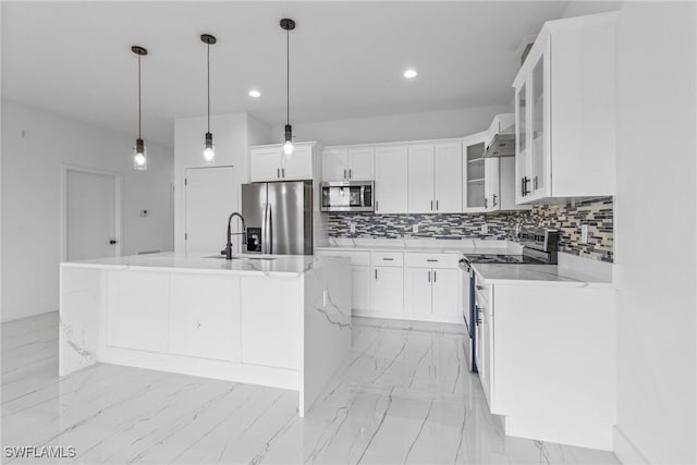 7071 Tide Cir, Labelle, FL 33935 - kitchen featuring appliances with stainless steel finishes, backsplash, an island with sink, white cabinetry, and recessed lighting