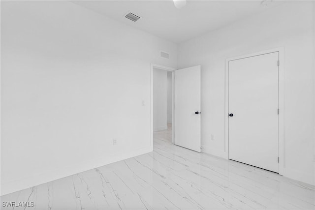 7071 Tide Cir, Labelle, FL 33935 - unfurnished bedroom featuring light marble finish floors and baseboards