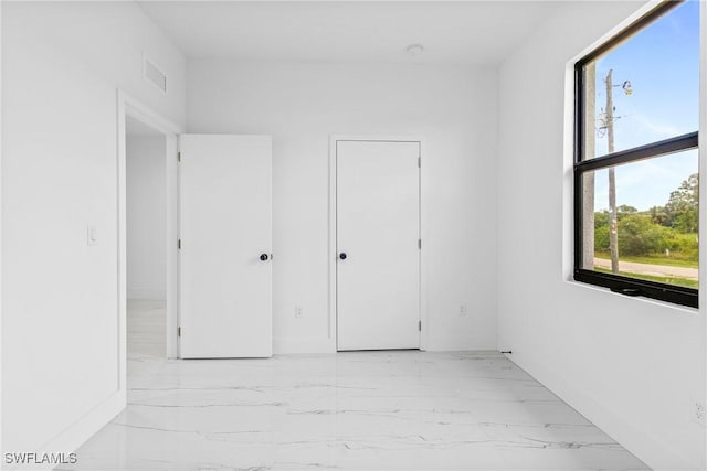 7071 Tide Cir, Labelle, FL 33935 - unfurnished bedroom featuring light marble finish flooring and baseboards