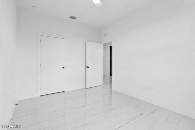 7071 Tide Cir, Labelle, FL 33935 - unfurnished bedroom featuring light marble finish floors and a ceiling fan
