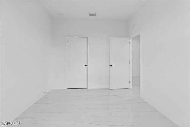 7071 Tide Cir, Labelle, FL 33935 - unfurnished bedroom with light marble finish floors and baseboards