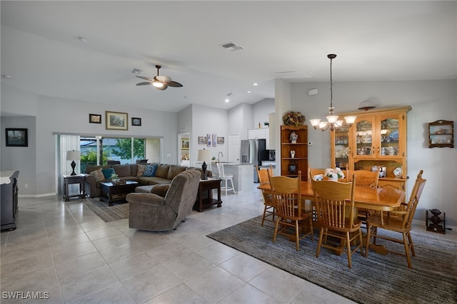 2804 NW 6th St, Cape Coral, FL 33993 - dining room with vaulted ceiling, a ceiling fan, light tile patterned floors, and a chandelier