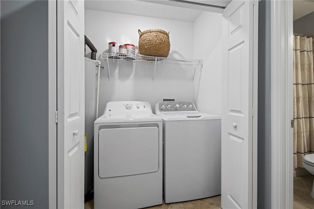 14040 Heritage Landing Blvd Unit 115, Punta Gorda, FL 33955 - washroom with washing machine and clothes dryer and light tile patterned floors