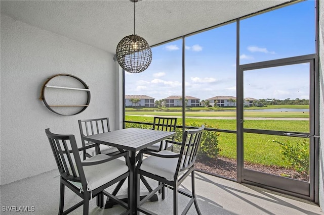14040 Heritage Landing Blvd Unit 115, Punta Gorda, FL 33955 - sunroom with outdoor dining area, a water view, a chandelier, and a residential view