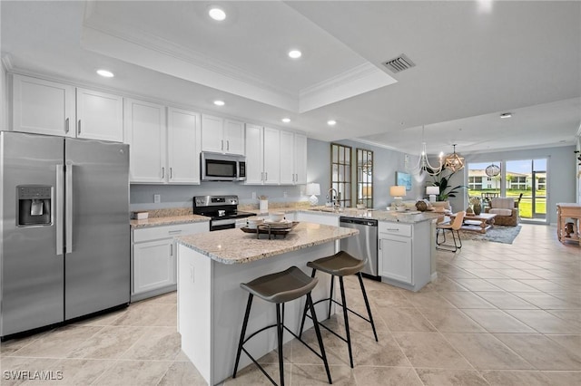 14040 Heritage Landing Blvd Unit 115, Punta Gorda, FL 33955 - kitchen with stainless steel appliances, a tray ceiling, crown molding, a peninsula, and recessed lighting