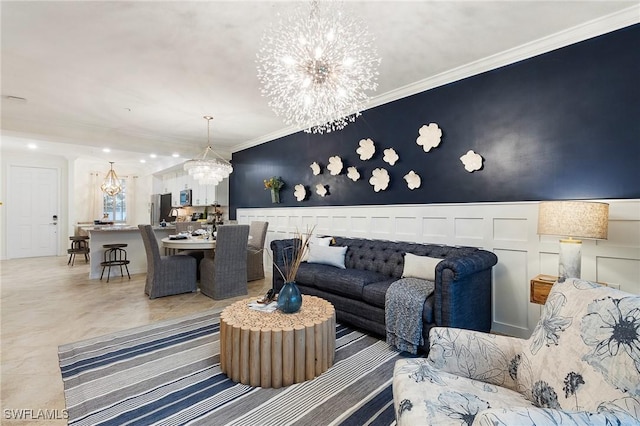 14040 Heritage Landing Blvd Unit 124, Punta Gorda, FL 33955 - living area featuring a chandelier, ornamental molding, a decorative wall, and a wainscoted wall