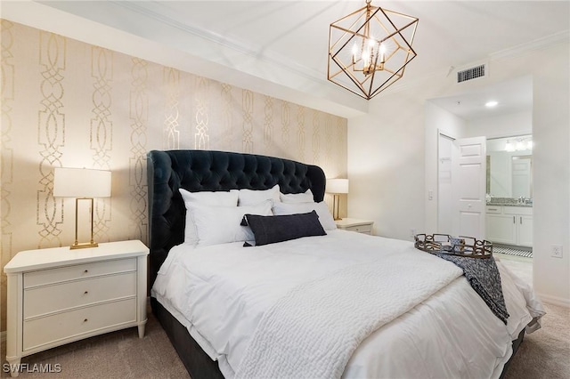 14040 Heritage Landing Blvd Unit 124, Punta Gorda, FL 33955 - carpeted bedroom with a chandelier, crown molding, and ensuite bathroom