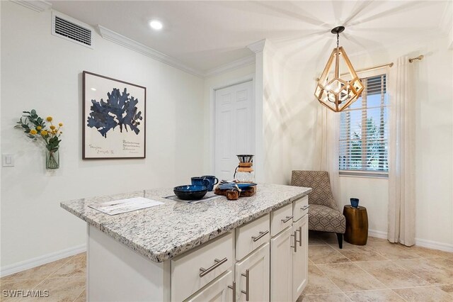 14040 Heritage Landing Blvd Unit 124, Punta Gorda, FL 33955 - kitchen featuring a chandelier, crown molding, a kitchen island, white cabinetry, and light stone counters