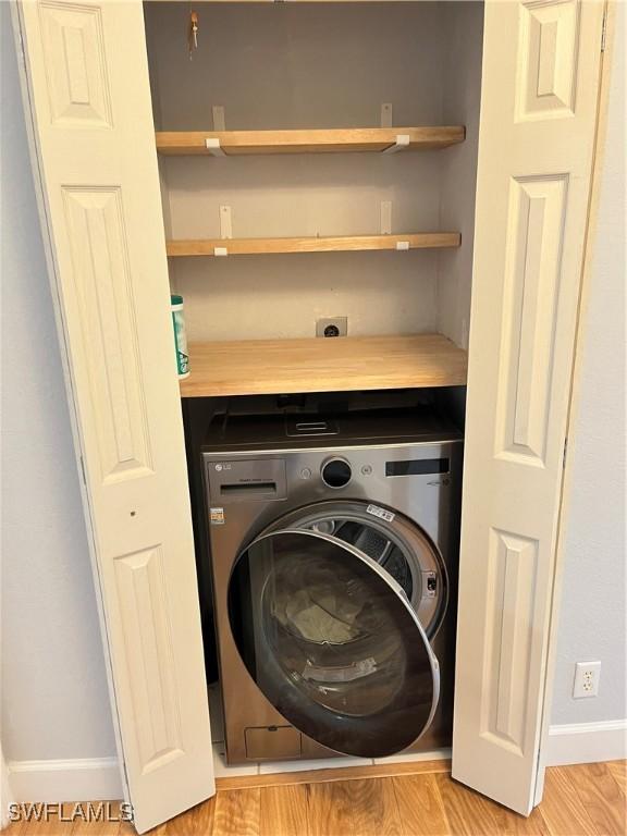 8241 Pacific Beach Dr, Fort Myers, FL 33966 - washroom featuring washer / dryer and light wood-style floors