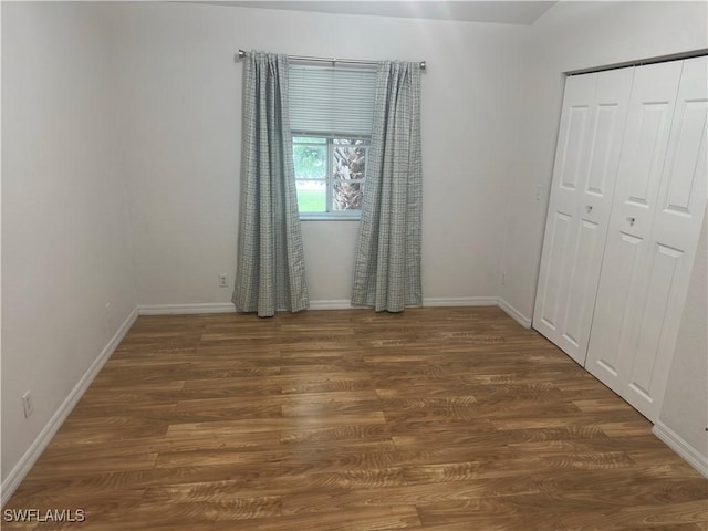 8241 Pacific Beach Dr, Fort Myers, FL 33966 - unfurnished bedroom featuring wood finished floors and a closet