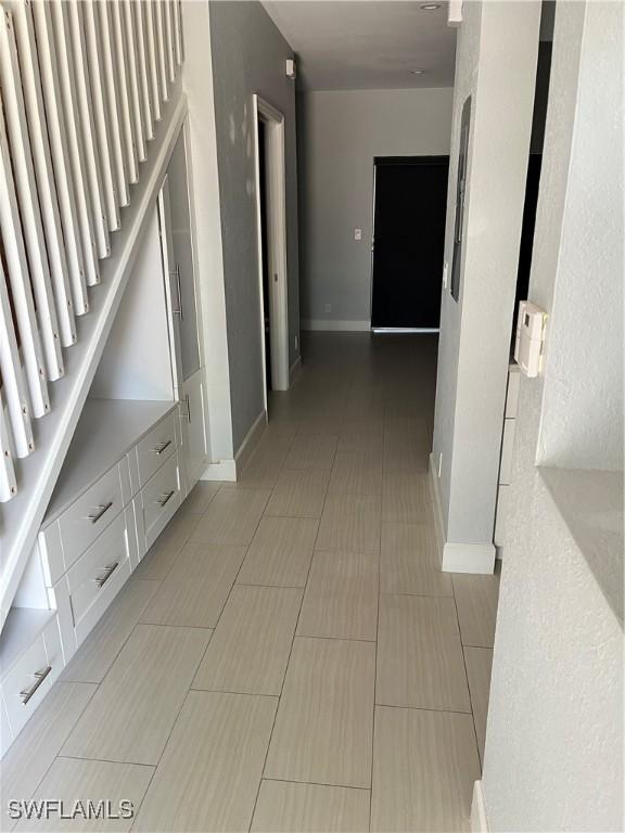 8241 Pacific Beach Dr, Fort Myers, FL 33966 - corridor featuring baseboards