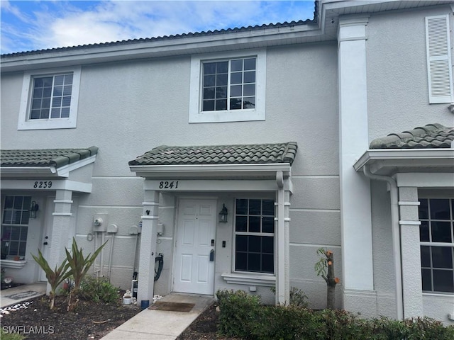 8241 Pacific Beach Dr, Fort Myers, FL 33966 - view of front facade featuring stucco siding and a tile roof