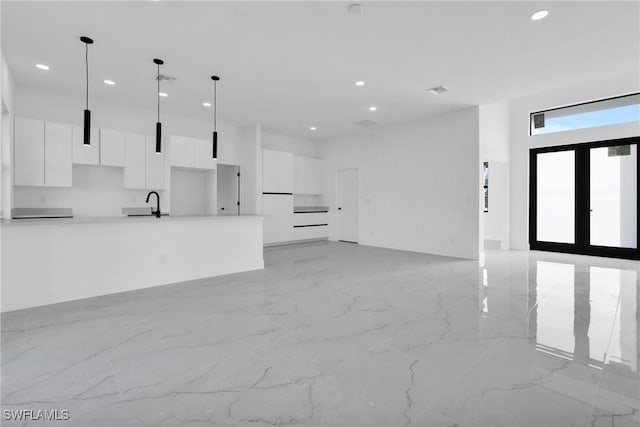 2616 42nd St W, Lehigh Acres, FL 33971 - unfurnished living room featuring light marble finish floors, recessed lighting, and a high ceiling